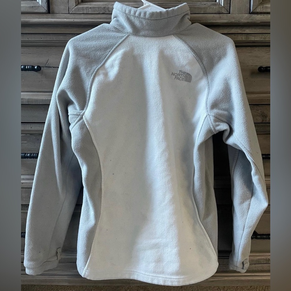 white and grey north face zip up